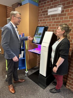 Samtgemeindebürgermeister Henning Fricke testet den neuen Selbstverbucherautomat
